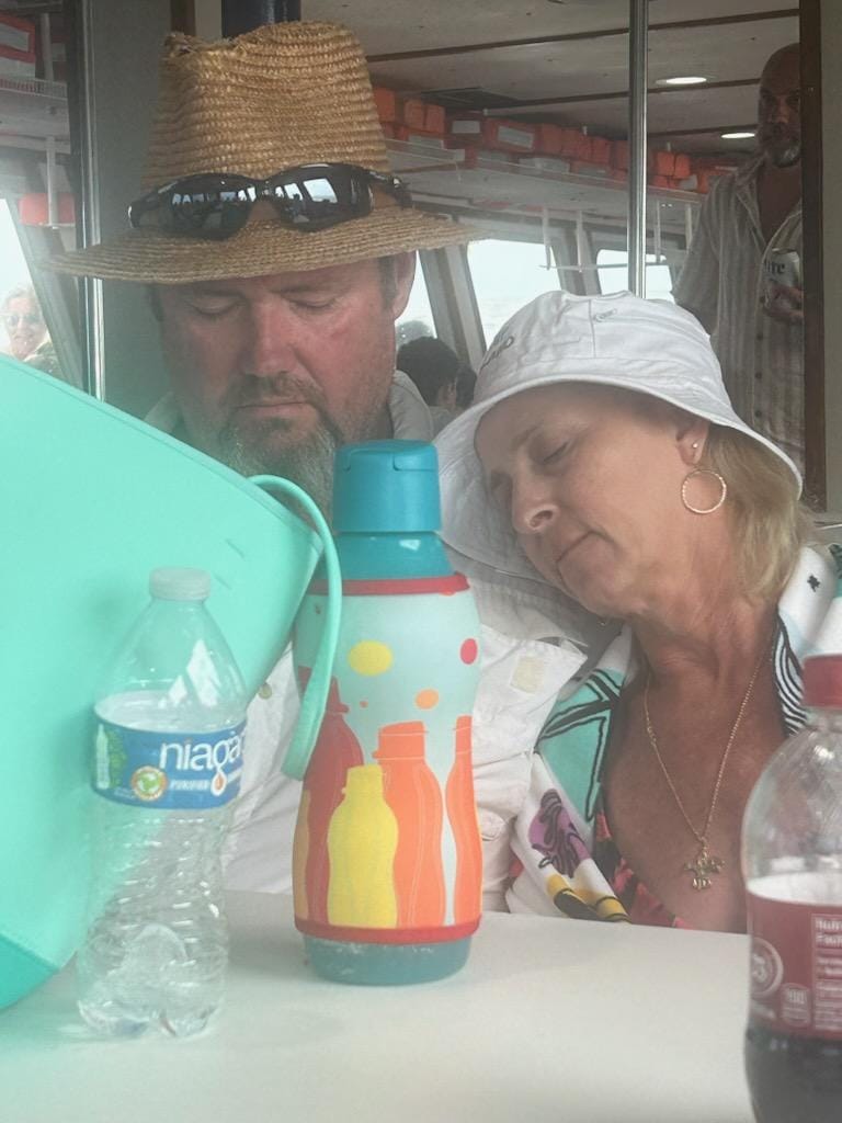 Lisa and Bubba on Ships Island ferry with an Eco+ bottle, showing eco-friendly kitchen wins on the move.