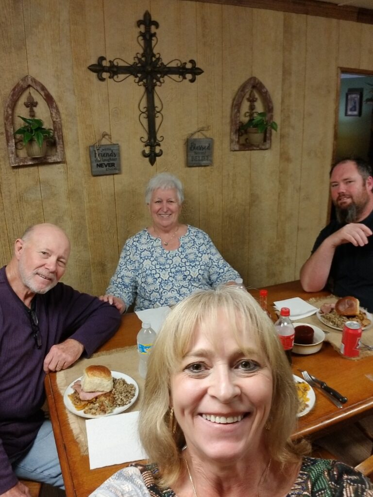Family gathered around the dinner table sharing laughter and home-cooked food — Make It Together theme from Your Bowl Connection.