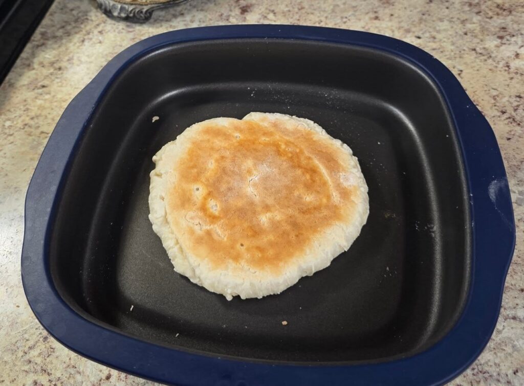 Homemade Cajun flatbread baked in a Tupperware MicroPro Grill on a kitchen counter — the first simple step in the Chaos to Cozy Kitchen System.