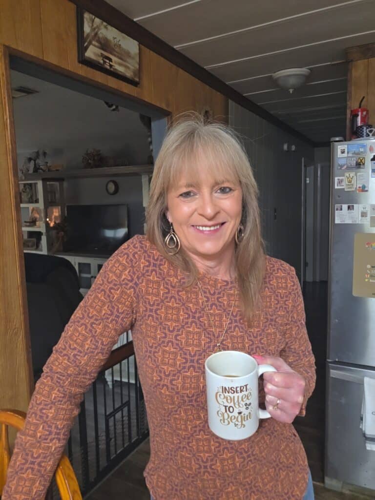 Lisa smiling in her Louisiana home while holding her coffee mug, sharing everyday stories and memories through Your Bowl Connection.